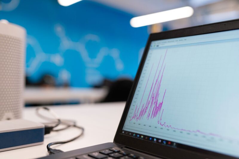 Laptop screen showing a website analytics dashboard with traffic graphs
