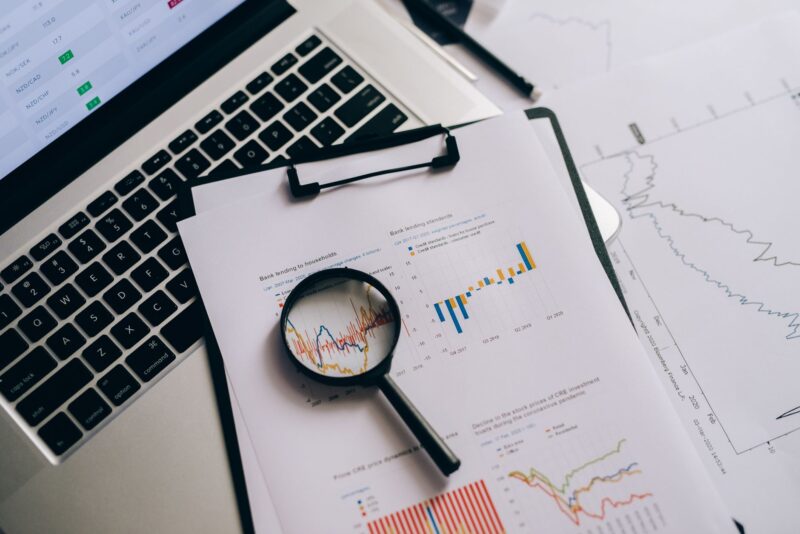 Programmatic SEO for Affiliate Sites: What Actually Scales Without Tanking Your Rankings 1 Laptop showing a spreadsheet and analytics dashboard on a desk with printed page templates, representing the planning behind programmatic SEO content.